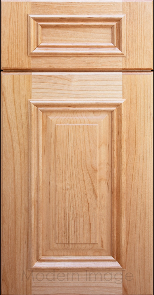 Natural stained Hamilton cabinet door with a double raised panel and mitered elevated molding.
